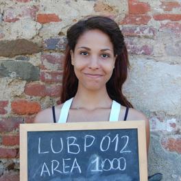 Brunette woman holding a chalkboard sign reading: LUBP Area 1000