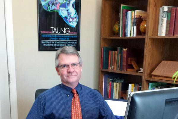 Dr. McKee with Taung poster