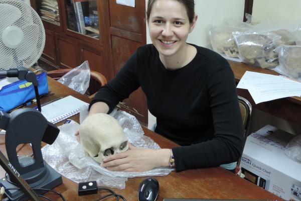 Photo of Dr. Noreen von Cramon-Taubadel holding skull
