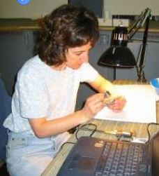 white woman examining artifact in laboratory