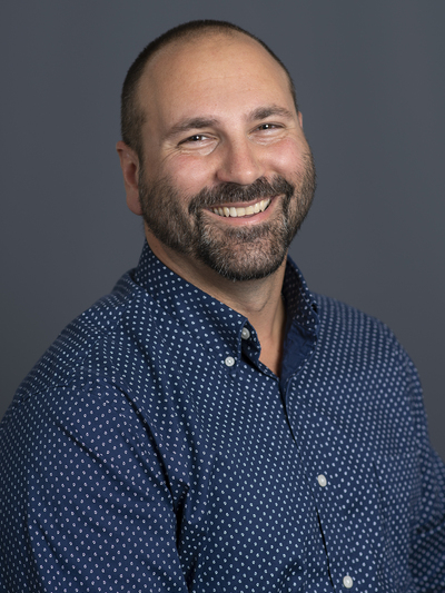 Dr. Nick Passalacqua. Middle aged white man smiling in a professional photo.