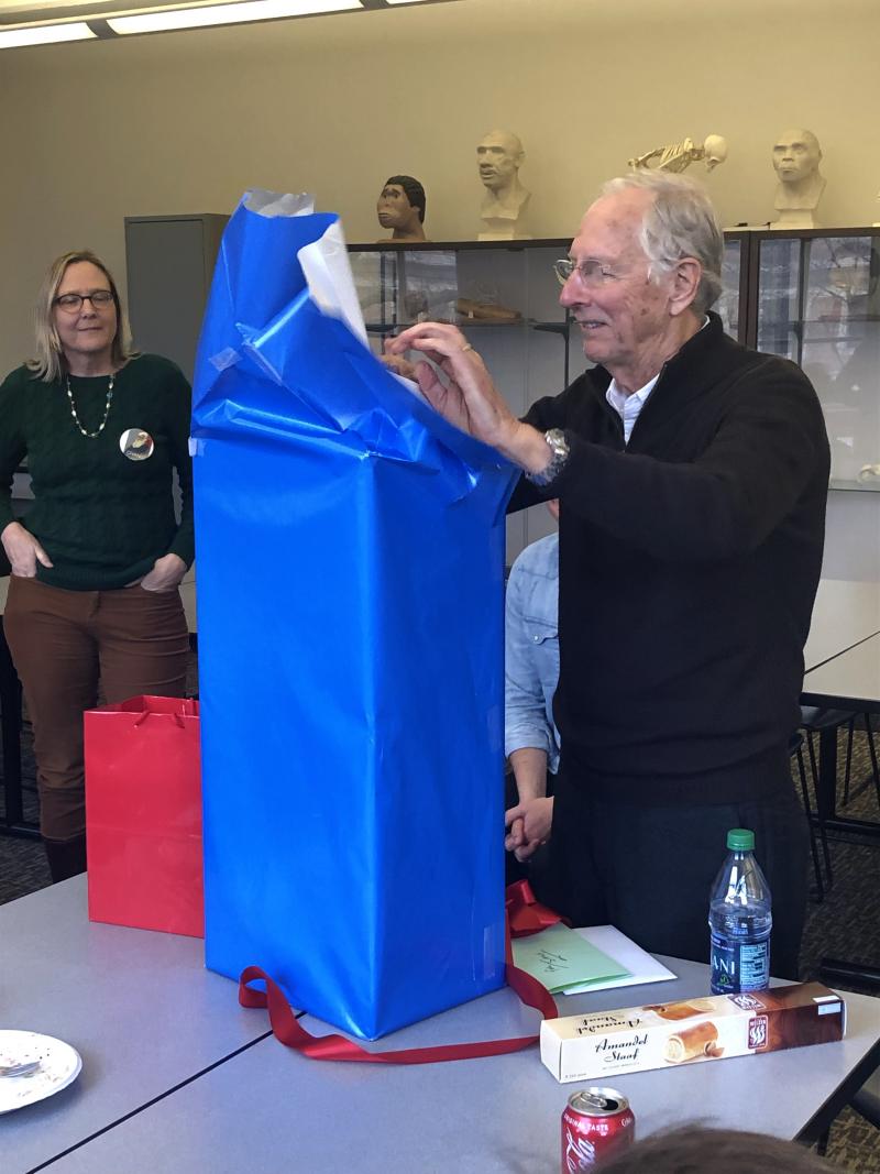 Sam Stout opening a gift at retirement reception