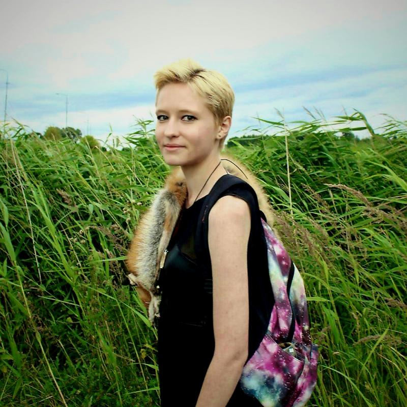 Image of Emma Brzezinski standing in a field of tall grass