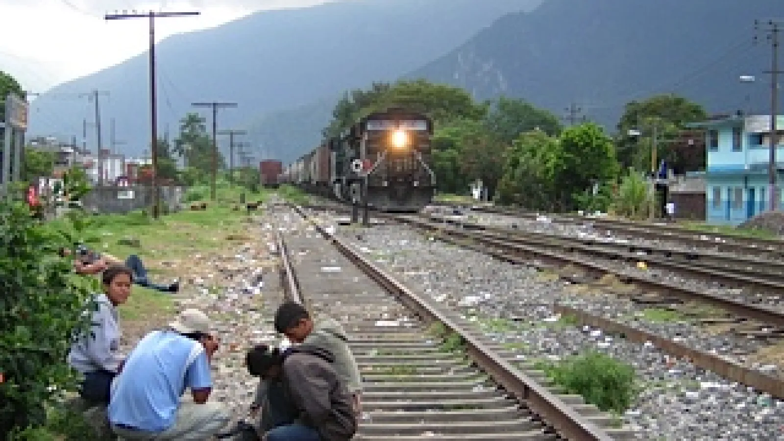 Migrants sitting on train tracks