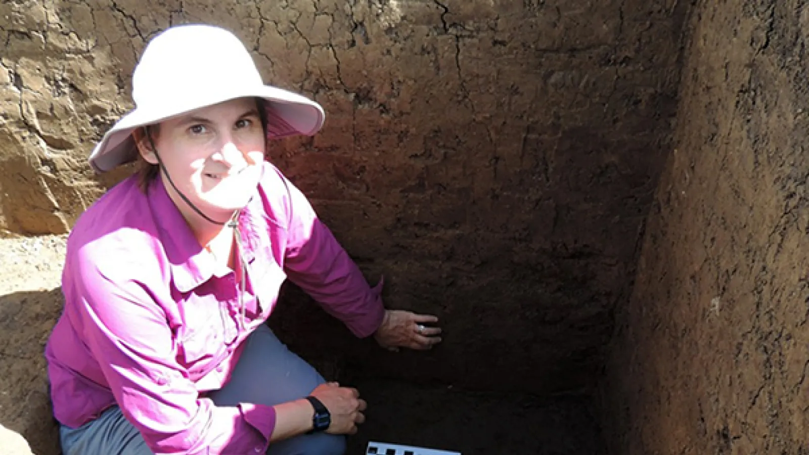 Woman in a white hat in an excavation pit