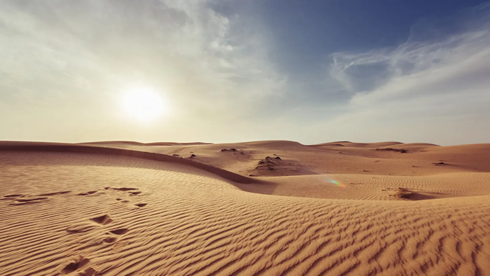 sand dunes with footprints and waves