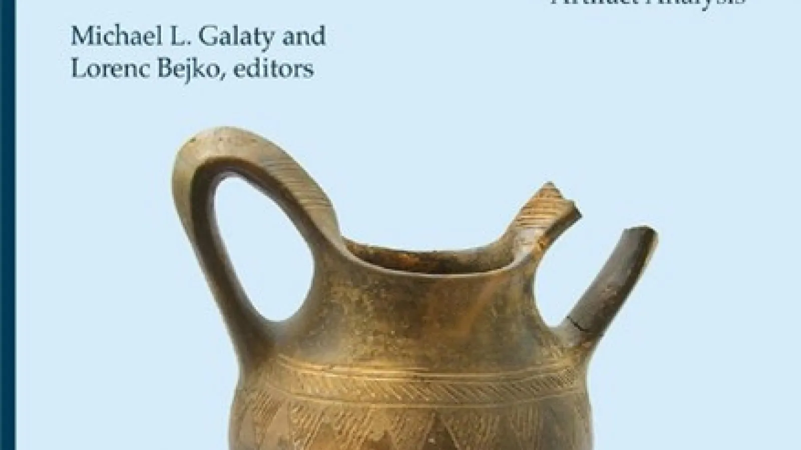 bronze colored water vessel on blue colored background