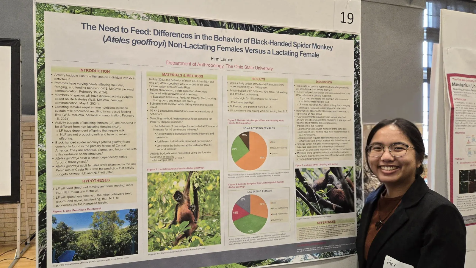 Smiling brunette student in front of their poster. 