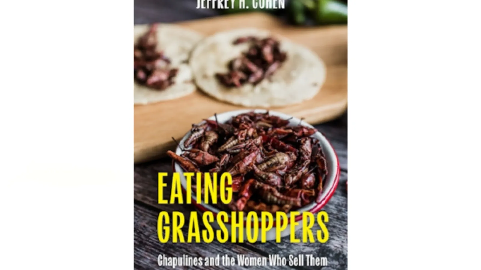 Book cover showing a bowl of grasshoppers on a wooden table