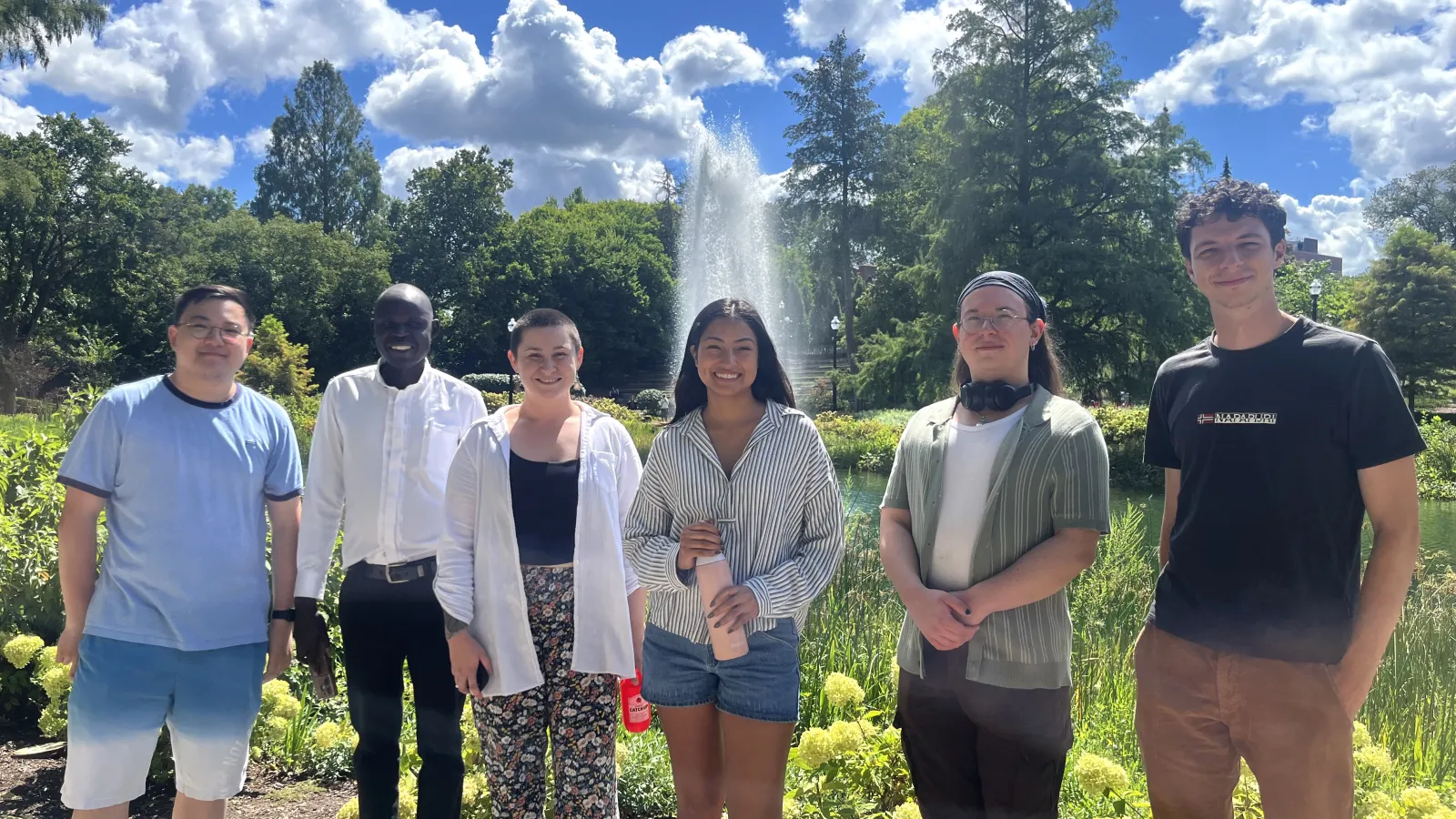 5 new graduate students smiling at the camera