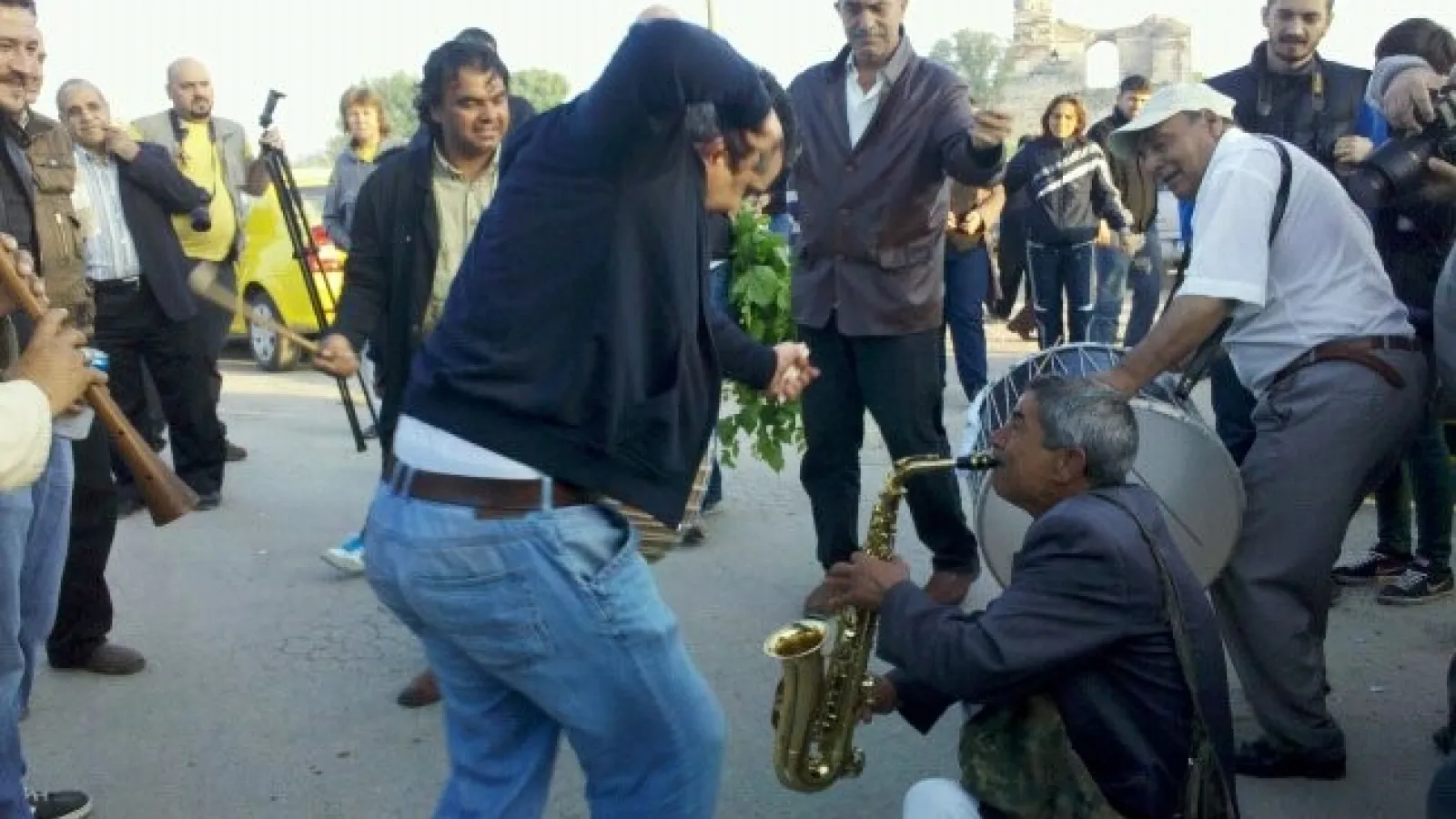 Men dancing and playing music in the street