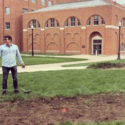Dr. Kawa Dr. Kawa stands in front of biosolids on the university campus