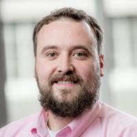 bearded man in pink shirt