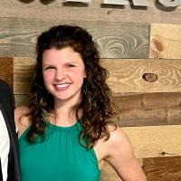 Smiling brunette woman in green top