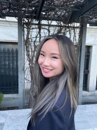 Smiling woman with long grey-brown hair
