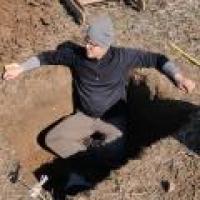 A Man sitting in a pit 