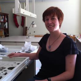 Auburn haired woman with a tray of bone fragments