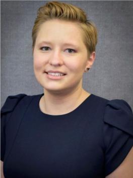 Smiling blond haired woman in dark blue shirt