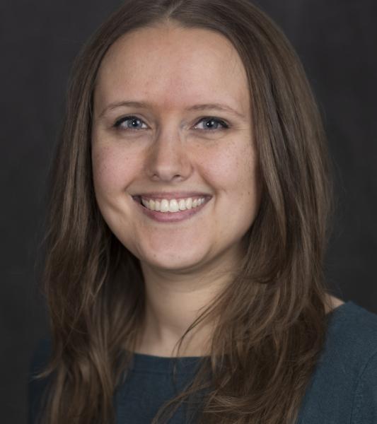 white woman with long brown hair smiling