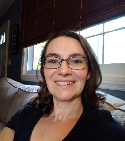 Brunette woman with glasses smiling