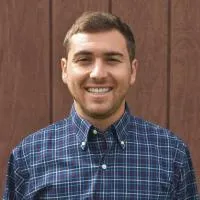 Smiling white man in blue checked shirt