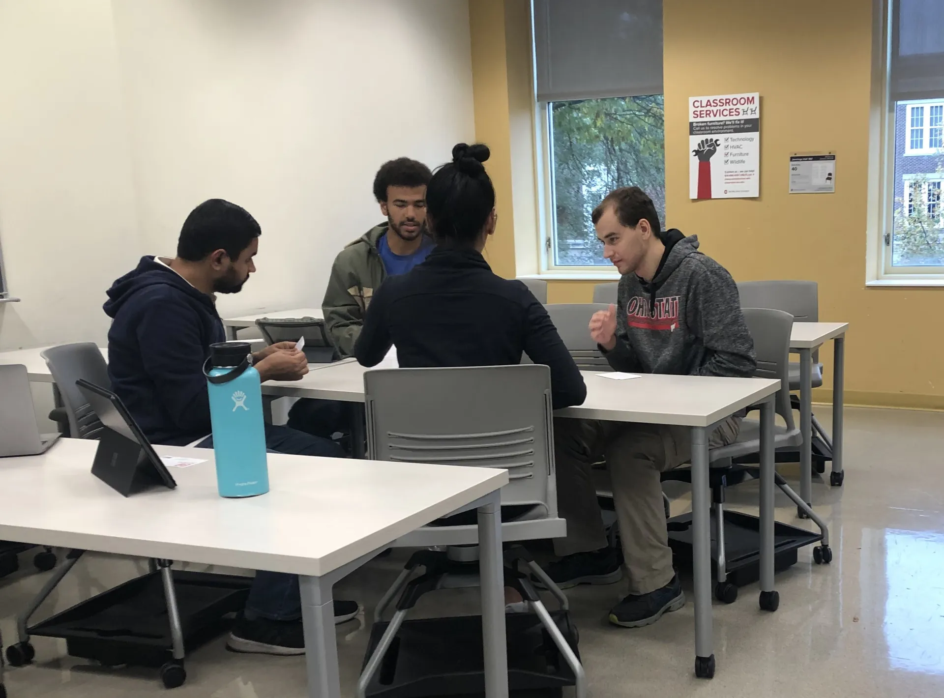 students collaborating together on a group project at a table