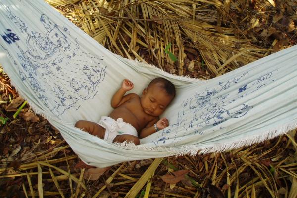 Infant asleep in a hammock.