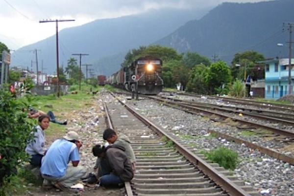 Migrants sitting on train tracks