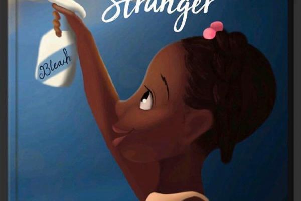 a black child holding up a face mask