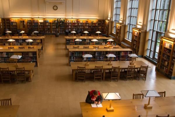 Library room with floor to ceiling windows and 2 rows of desks