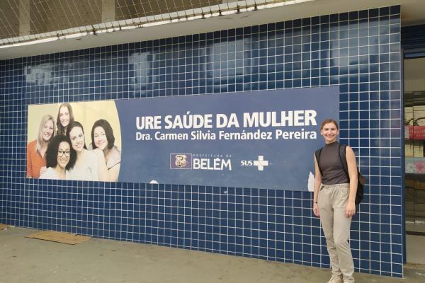 Staphanie Fannin in front of poster supporting maternal health