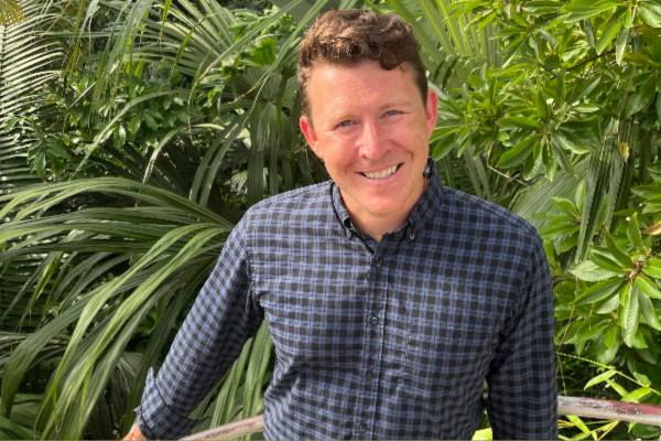 Kawa Headshot in area surrounded by plants