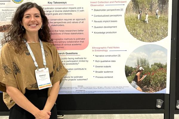 Maddison Elliott in front of her poster for the Entomological Society of America Conference 