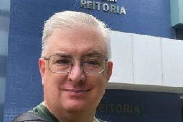 White man standing in front of the Federal University of Amazonas building