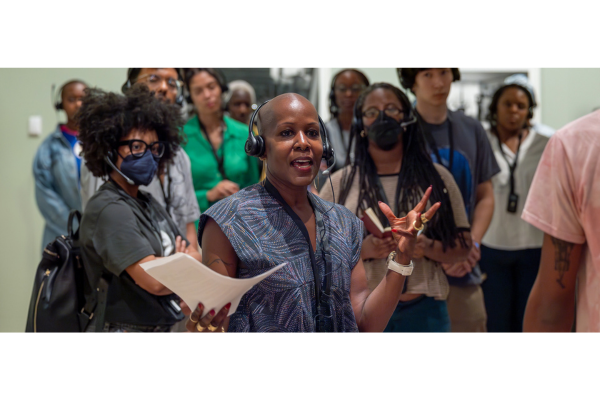 a professor and group of students singing durring class
