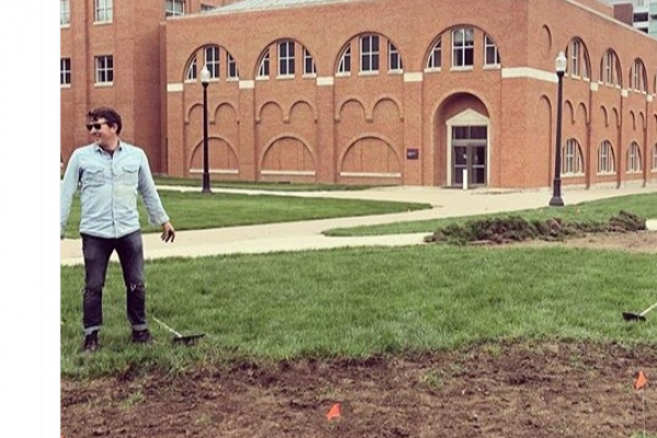 Dr. Kawa Dr. Kawa stands in front of biosolids on the university campus