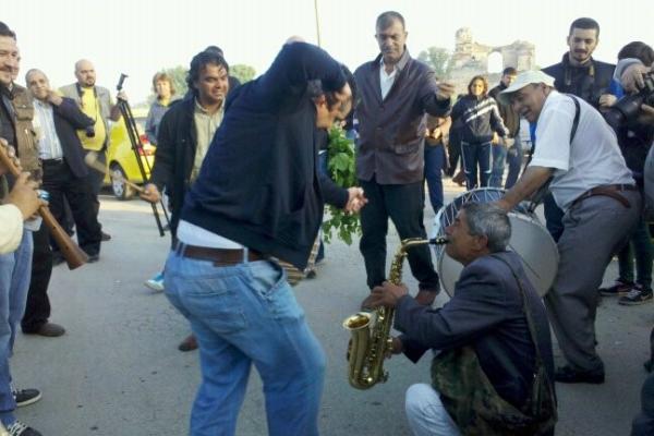 Men dancing and playing music in the street