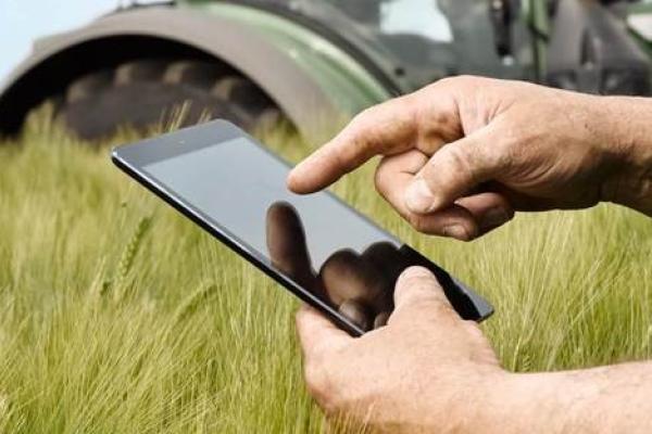 Man using ipad in the field Man using ipad in the field