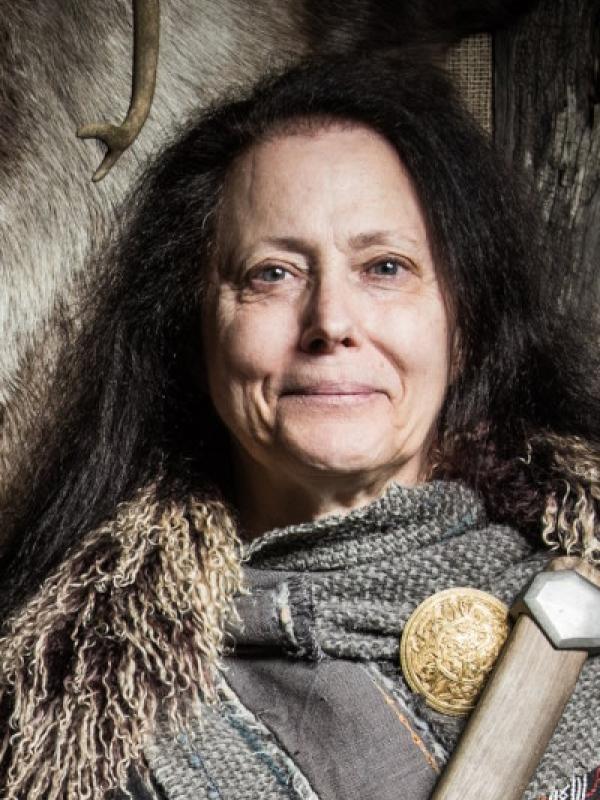 Smiling brunette woman in Viking garb