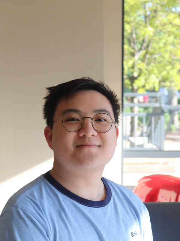 Smiling dark haired man in glasses