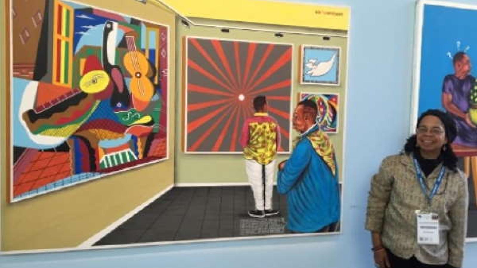 Jules-Rosette Bennetta in front of the painting Non Comprendre (1995) by Cheik Ledy