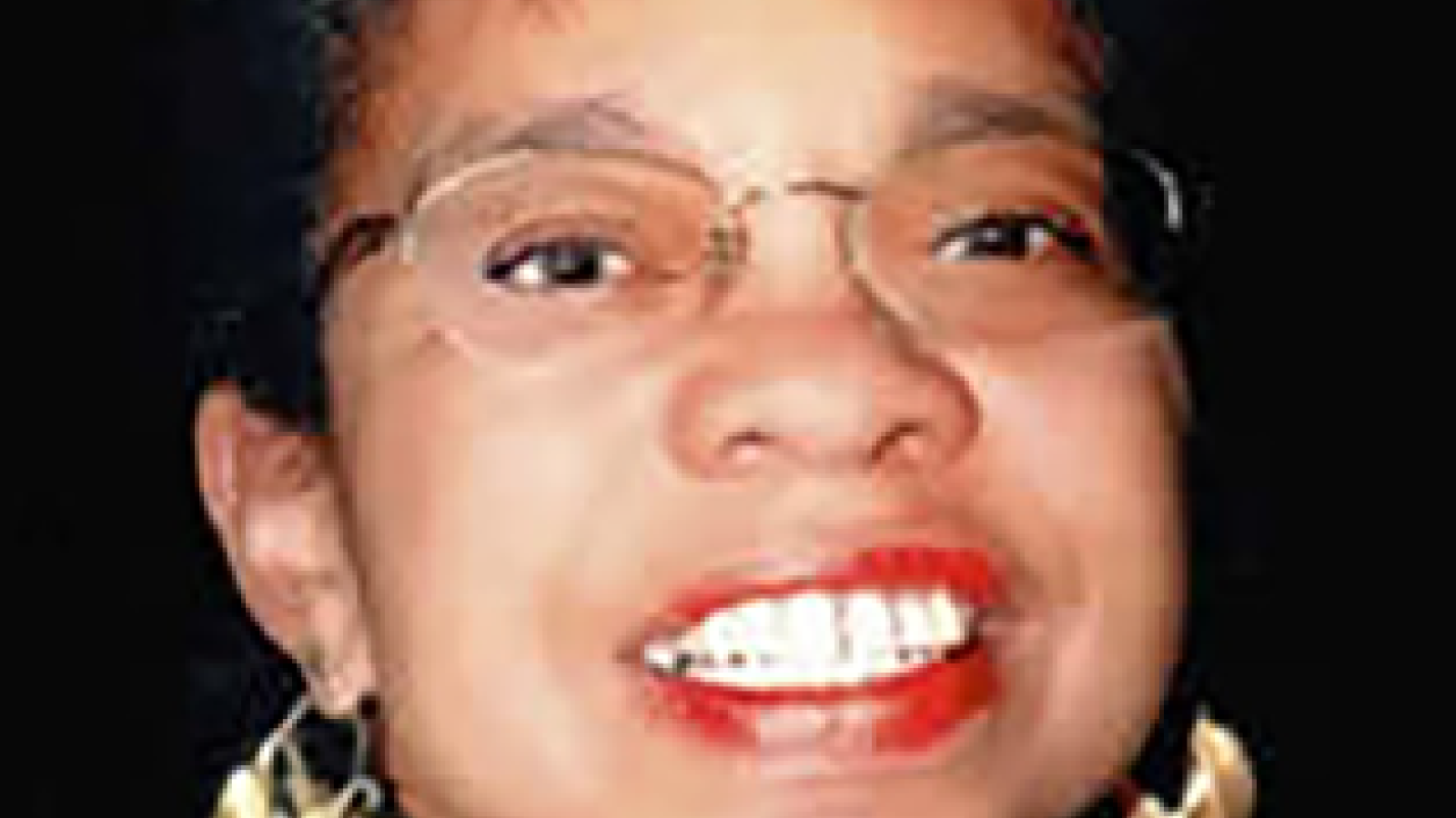 Smiling dark haired woman wearing glasses