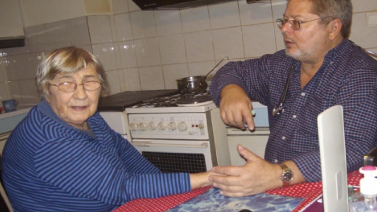 A man sitting with an elderly woman in Slovenia