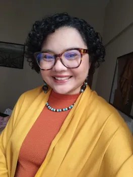 Smiling brunette woman with red glasses