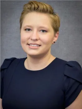 Smiling blond haired woman in dark blue shirt