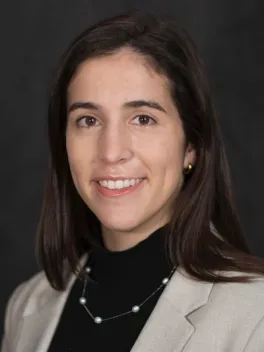 Smiling white woman with dark hair and brown eyes