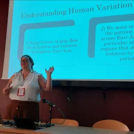 Woman standing in front of a projection screen, lecturing