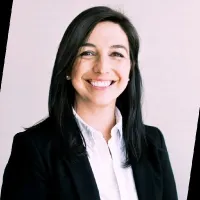 Smiling black haired woman in black suit