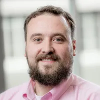 bearded man in pink shirt