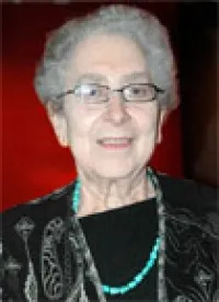 Smiling grey haired woman wearng glasses
